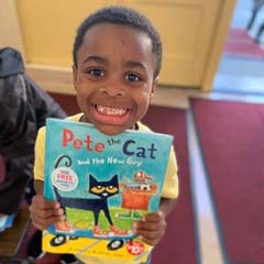 smiling child holding book
